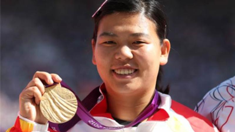 A picture of a chinese woman showing her gold medal