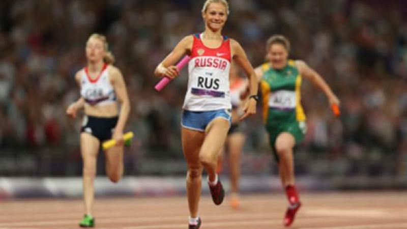 A picture of a woman running on a track 