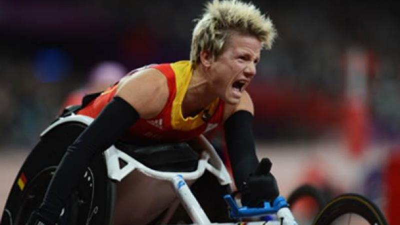 A picture of a woman in a wheelchair screaming after her victory in an athletics race