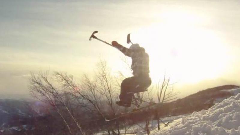 A picture of a man in a sledge skiing