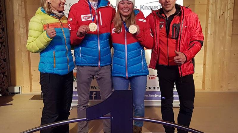 A young boy and girl with a man and a woman posing for the photo