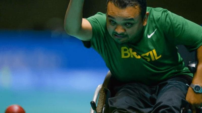 Man in wheelchair throwing a boccia ball