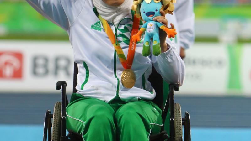 Gold medalist Asmahan Boudjadar of Algeria poses on the podium at the medal ceremony for women's shot put at Rio 2016.