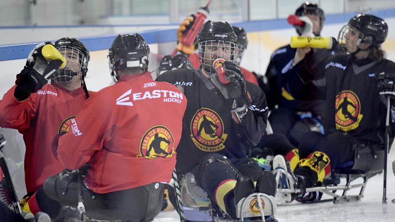 a group of Para ice hockey athletes on the ice