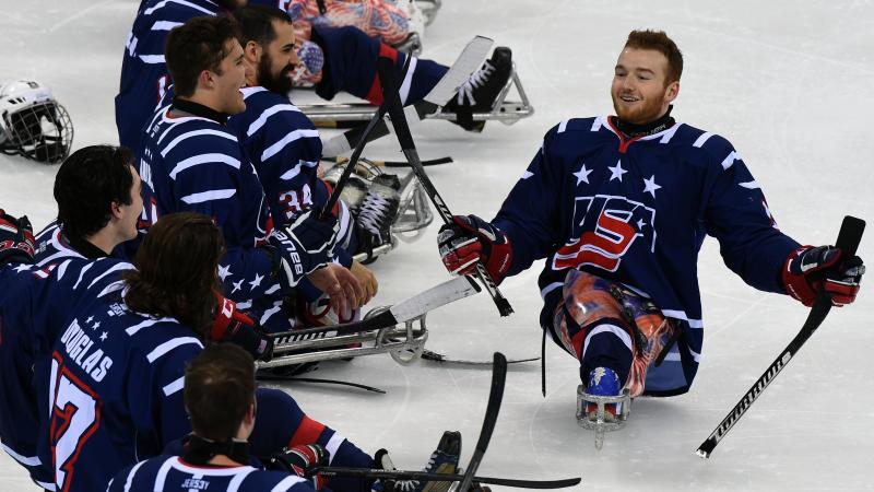Two Para ice hockey players smile after a game