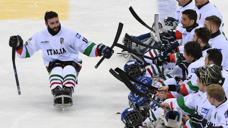 A Para ice hockey player celebrates a game win