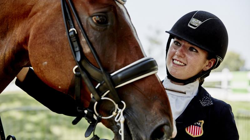 Woman pets horse 