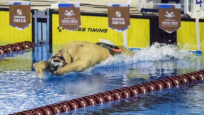 A swimmer with limb impairments starts his race