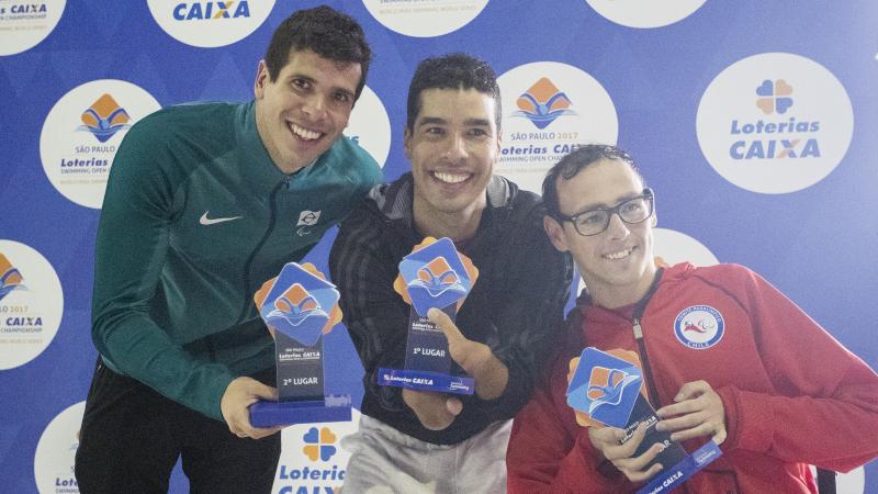 Para swimmers celebrate their podiums