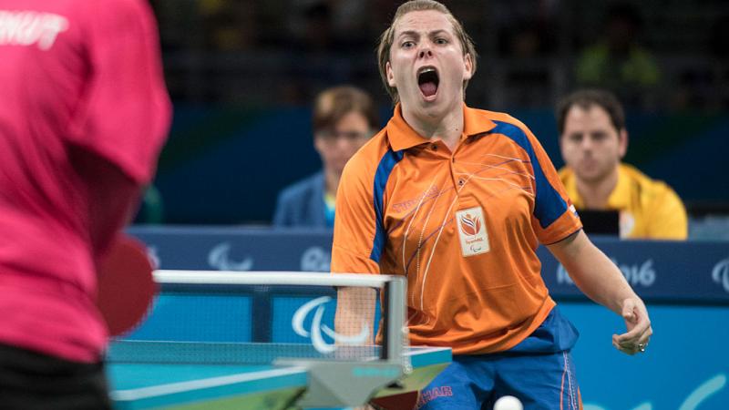 Female table tennis player celebrates after a point