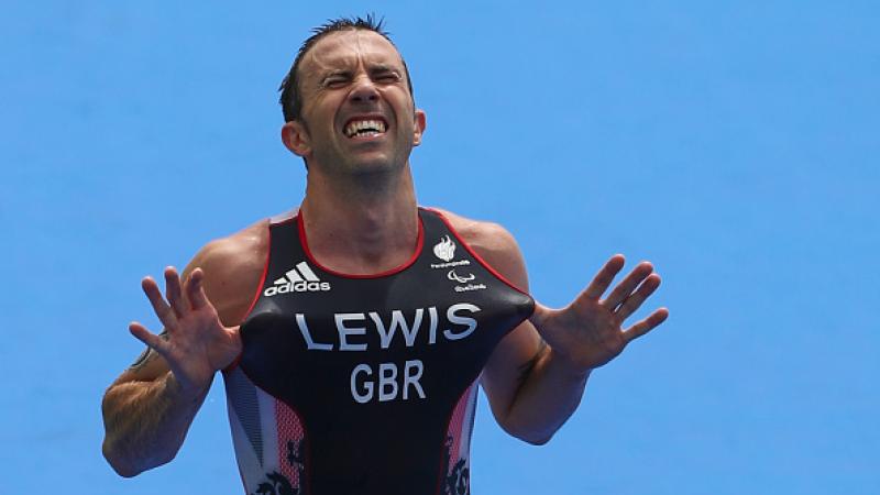 Male triathlete celebrates after winning race