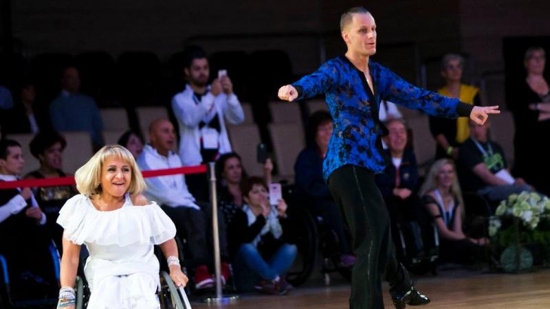 Woman in wheelchair dances with standing male partner 