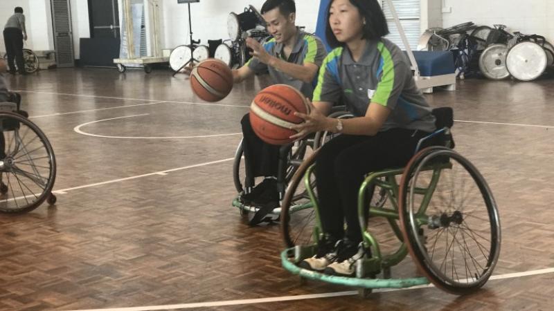 Woman in wheelchair shooting a basketball