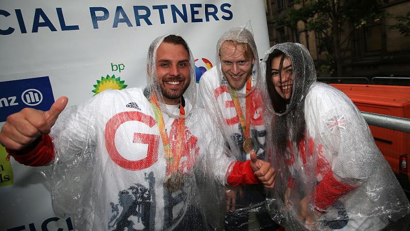 Julie Rogers smiles alongside Aled Davies and Jonnie Peacock at Rio 2016 victory parade
