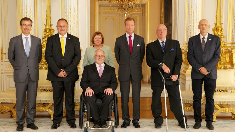 A group of people smiling for an official photograph