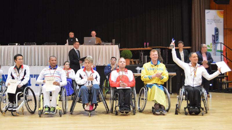 Five male wheelchair dancers on the podium