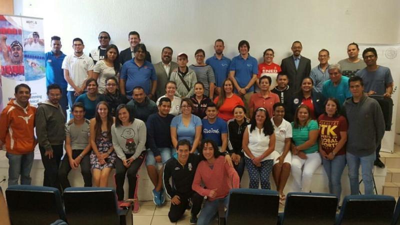 group of people in a room smiling