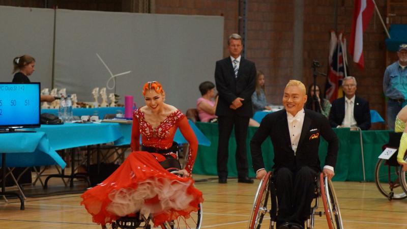 a male and female wheelchair dancer side by side