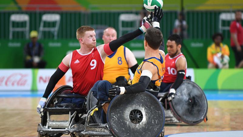 two men contesting the ball in wheelchairs
