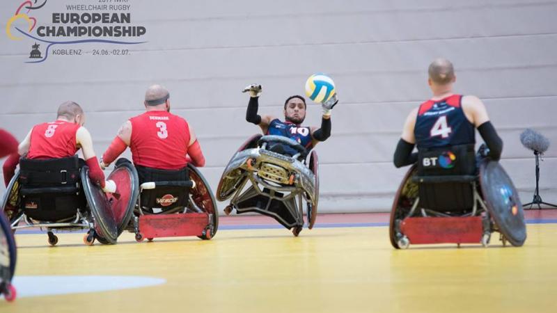 men tackle for the ball in wheelchairs
