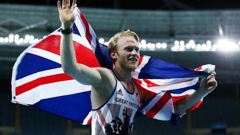 man runs with a British flag