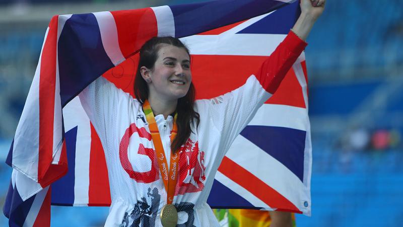 a woman holds up a flag