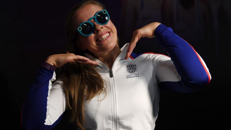 A girl in sunglasses poses for the camera