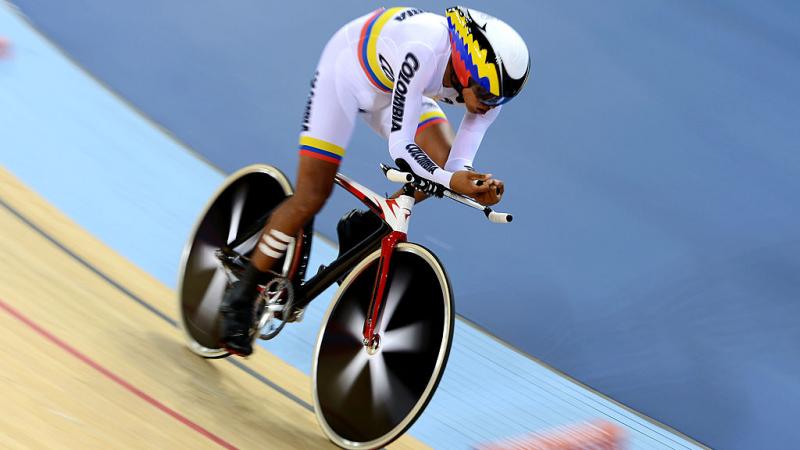 a para cyclist rides around the track