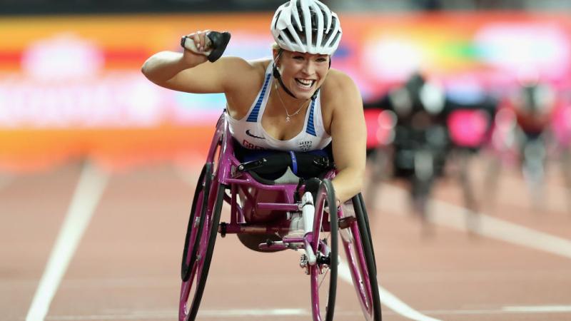 Girl in racing wheelchair celebrates