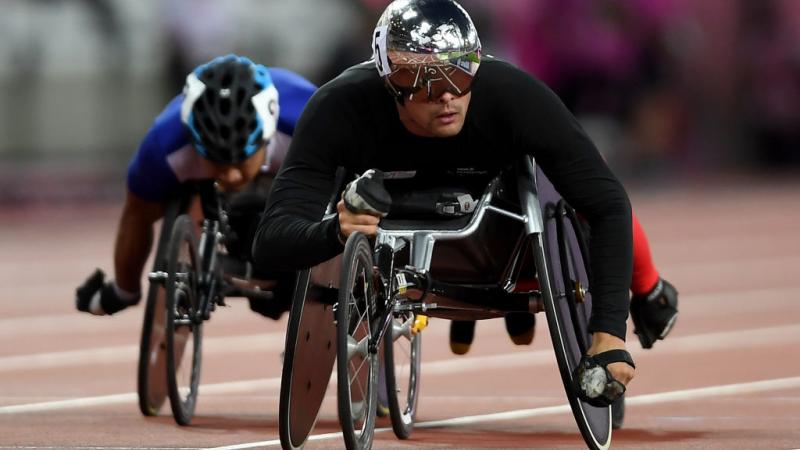 a wheelchair racer crosses the finish line