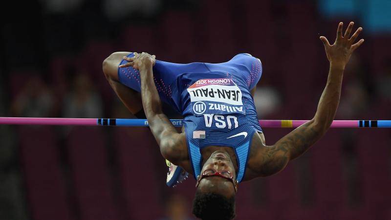 A man mid-leap in the high jump clearing the bar