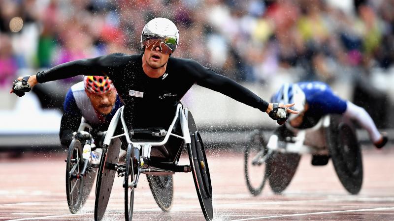 The Swiss Silver Bullet celebrates in the rain after winning the men's 5,000m T54 at London 2017.