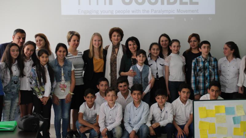 a group of schoolchildren pose for a photo 