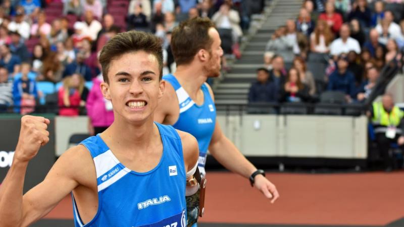 a para athlete celebrates by shaking his fist