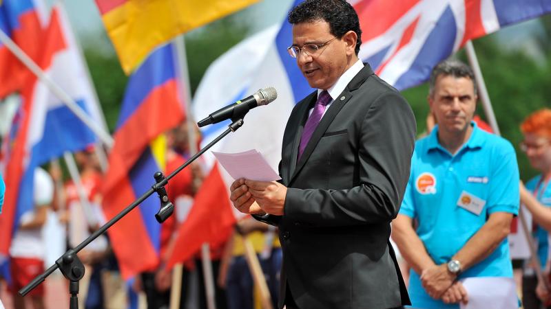 a man speaks at a podium