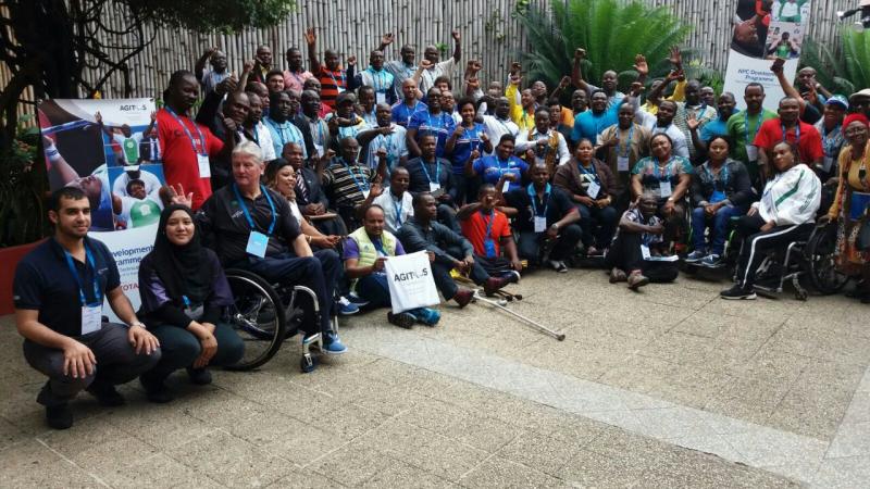 a group of people wave at the camera