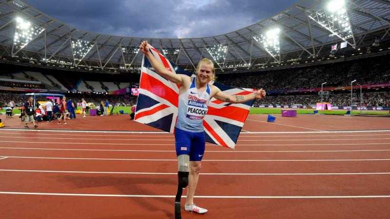 a Para sprinter celebrates winning with a Great Britain flag