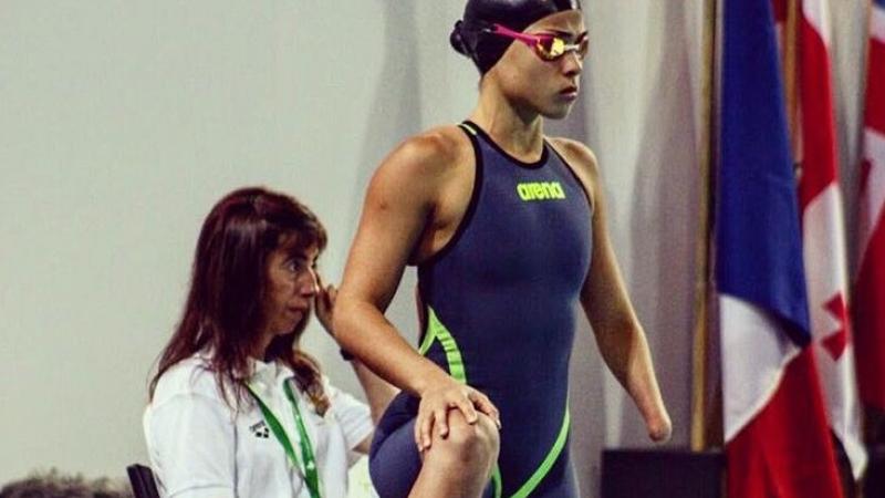 a female Para swimmer waits by her lane