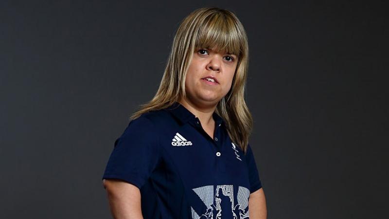 a female powerlifter looks into the camera