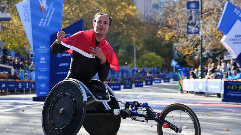 a male wheelchair athlete celebrates his win