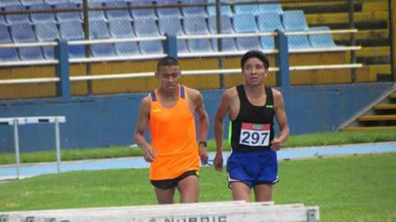 a Para athlete and his guide race on a track