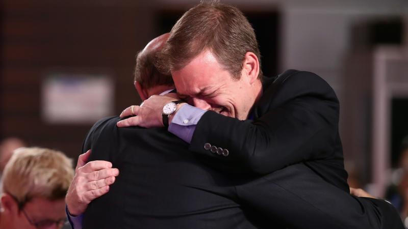 Two men hugging