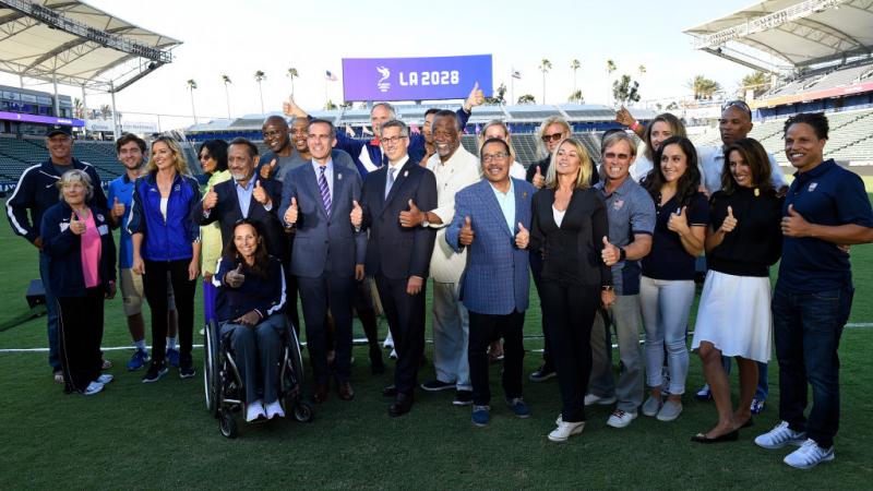 a group of people smiling in a stadium