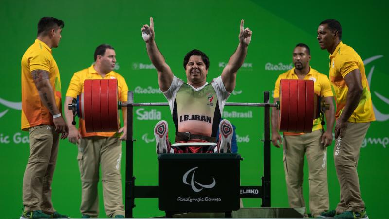 a Para powerlifter celebrates on the bench