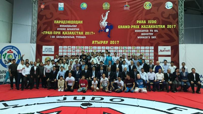 Group of people from a judo event pose for a photo