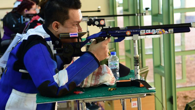 Man competing in R9 (mixed 50m rifle prone SH2) event 