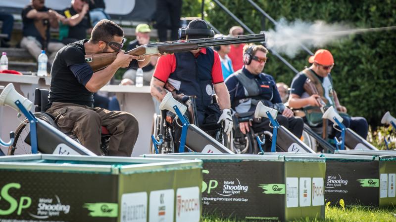 Man shoots a shotgun during a competition 