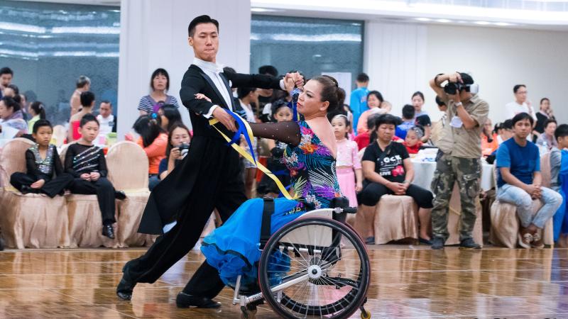 Woman in wheelchair dances with standing partner