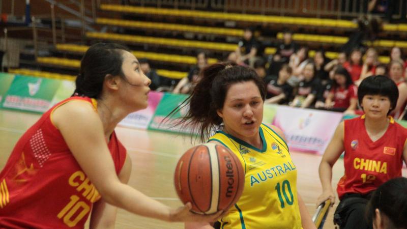 female wheelchair basketball players battle for the ball