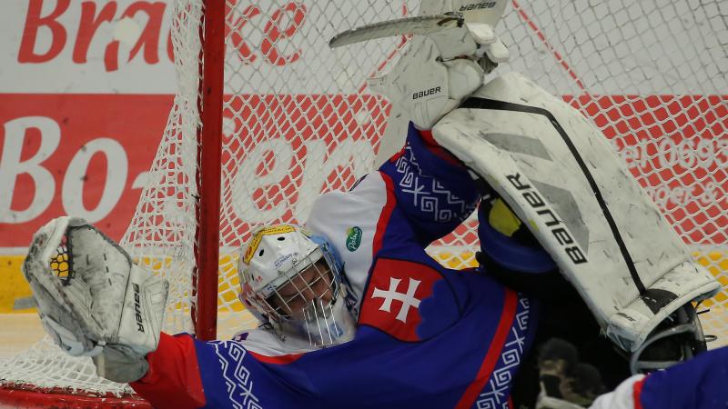 a Para ice hockey goalie saves a shot